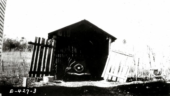 Old wooden garage with an old car in it