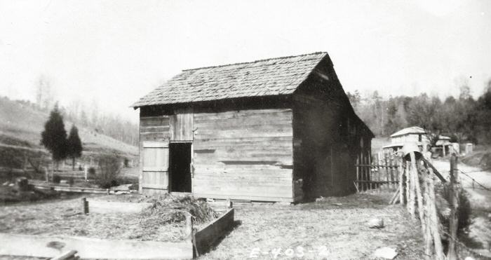 Large old wooden garage/barn with farm scenery